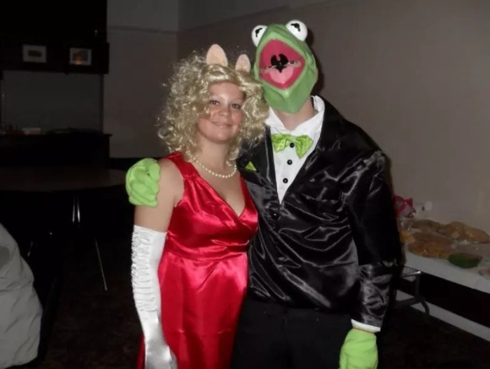 miss piggy and kermit the frog, dynamic duo ideas, inspired by the muppet show, woman in a red dress, with long white gloves, wearing a blonde curly wig, and pig ears, hugged by a man in a tuxedo, with a kermit mask