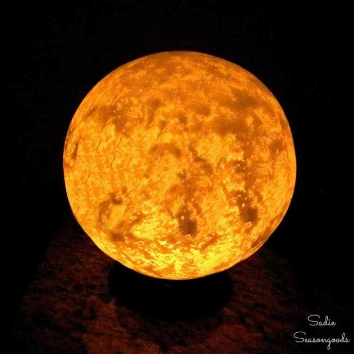 finished glowing moon lamp, halloween witch decorations, round white lamp, painted with beige on the inside, to resemble the moon