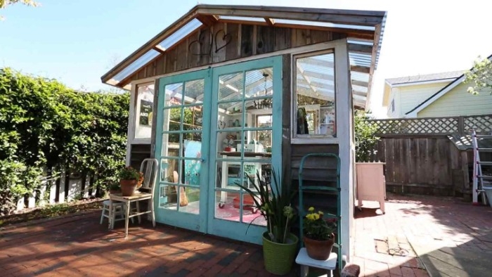 greenhouse style shed, with glass panels on the roof, lots of windows, and two glass doors, garden shed ideas, brown and white and pale blue color scheme