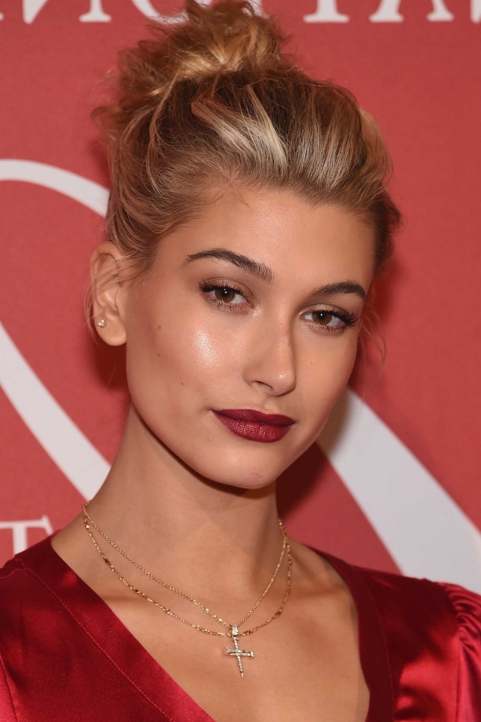 natural looking makeup, worn by a blonde woman, with dark red lipstick, subtle nude beige eyeshadow 