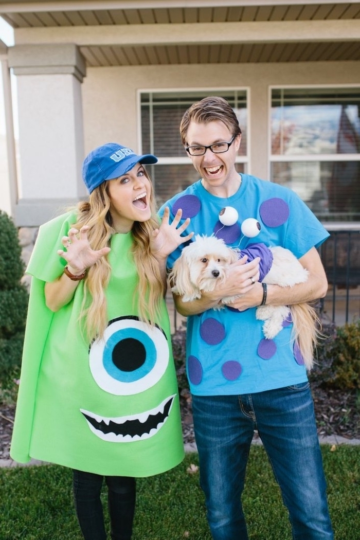 sully and mike from monster's ink, cute couple halloween costumes, worn by a young blonde girl, and a man with glasses, holding a dog in costume
