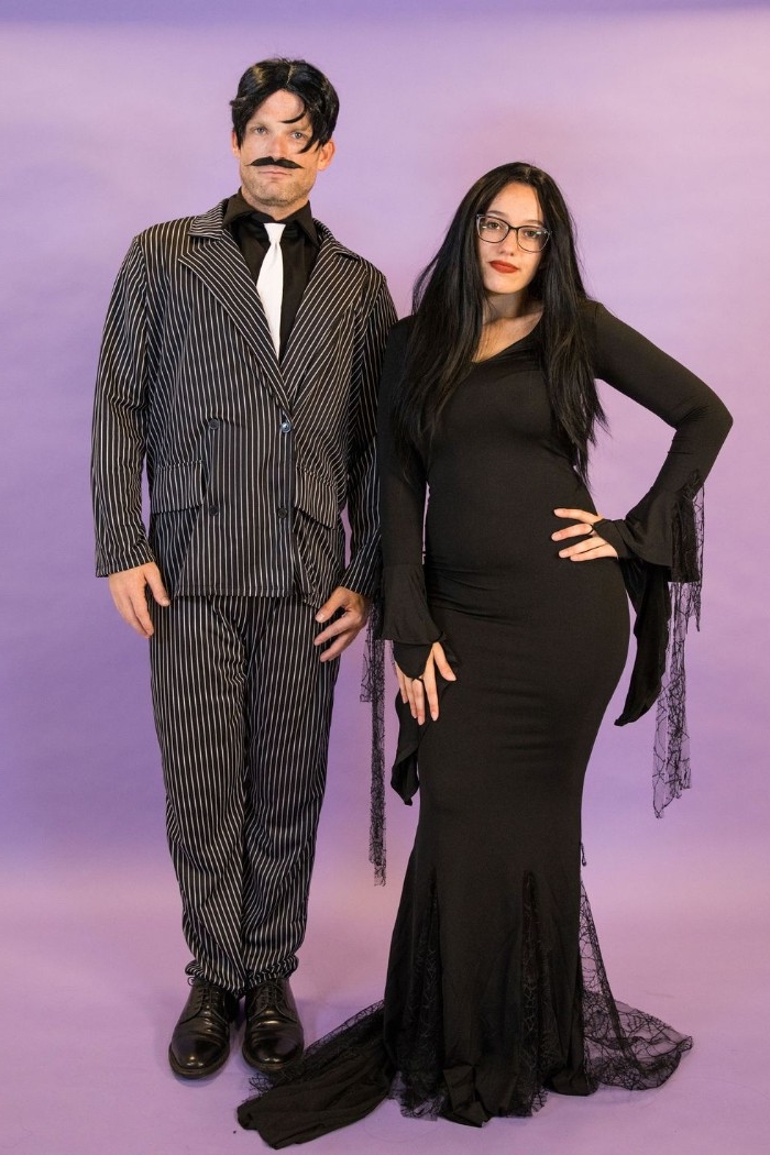 addams family-inspired outfits, woman in a black wig, dressed in a black maxi dress, and man with a faux mustache, in a striped suit, duo halloween costumes, duo halloween costumes, gomez and morticia