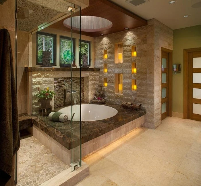 eight candles decorating the wall, of a spa-like bathroom, with pale creamy tiled floor, round white elevated bathtub