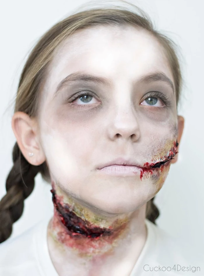 strongly illumianted image of a young girl, her face painted to look like a zombie, facepaint ideas, gory realistic scars, pale white skin