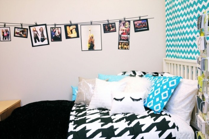 teenager's room in white, black and teal, with many different photos, hanging on a rope, and attached with clothes pegs