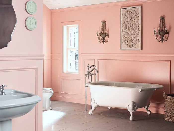 baby pink walls, inside a spacious bathroom, with a vintage style, white clawfoot bath, bathroom color schemes