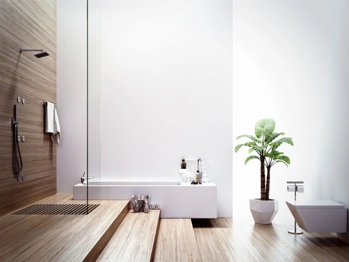 rectangular bathtub in white, inside a room with wooden floors, and an open plan showe area, master bathroom ideas, potted plant and a toilet seat