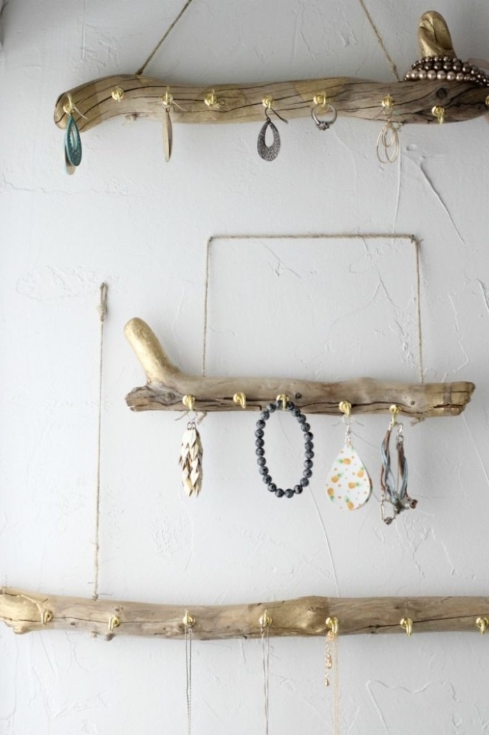 hanging jewelry stands, made from three pieces of polished driftwood, how to decorate your room, gold colored hooks, and handles made of rope