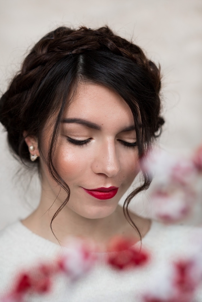 blush in peach pink, on the cheeks of a young woman, with dark brunette hair, wearing red lipstick, and a white top