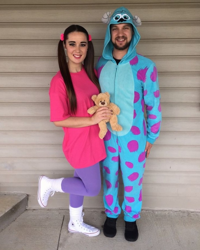 monsters inc. inspired costumes, man in a blue and purple onesie, woman in violet leggings, and a pink t-shirt, and holding a teddy bear, duo halloween costumes, sullivan and boo