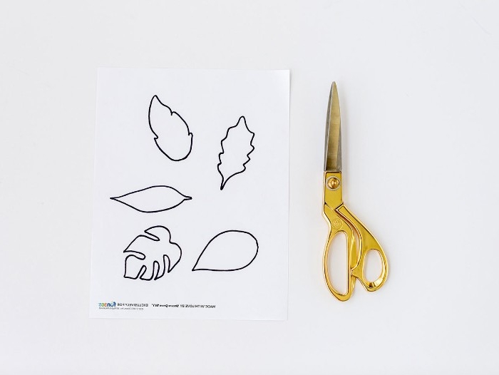 how to make diys for your room, a pair of scissors, with gold-colored handles, and a sheet of white paper, with several leaf outlines