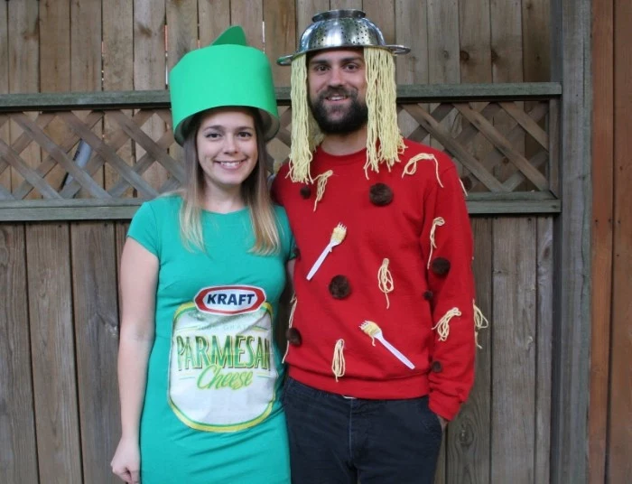 man with a colander, and some moodles on his head, dressed in a red jumper, decorated it faux spaghetti, forks and meatballs, funny couple halloween costumes, hugged by a smiling woman, dressed like parmesan