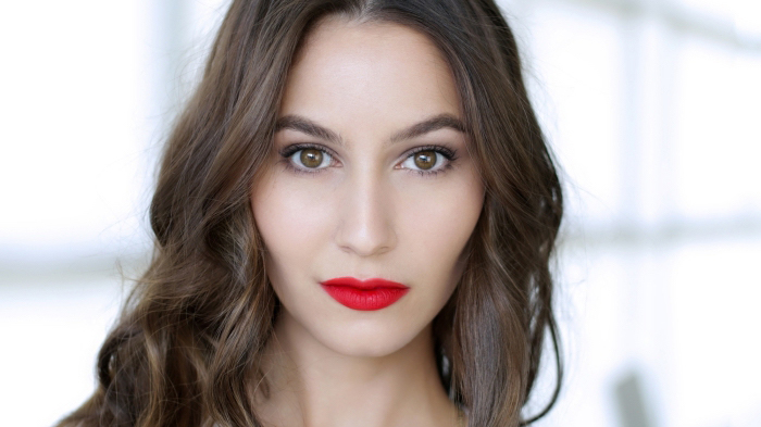 chocolate brunette wavy hair, on a pale, brown-eyed woman, wearing bright red lipstick, and black mascara