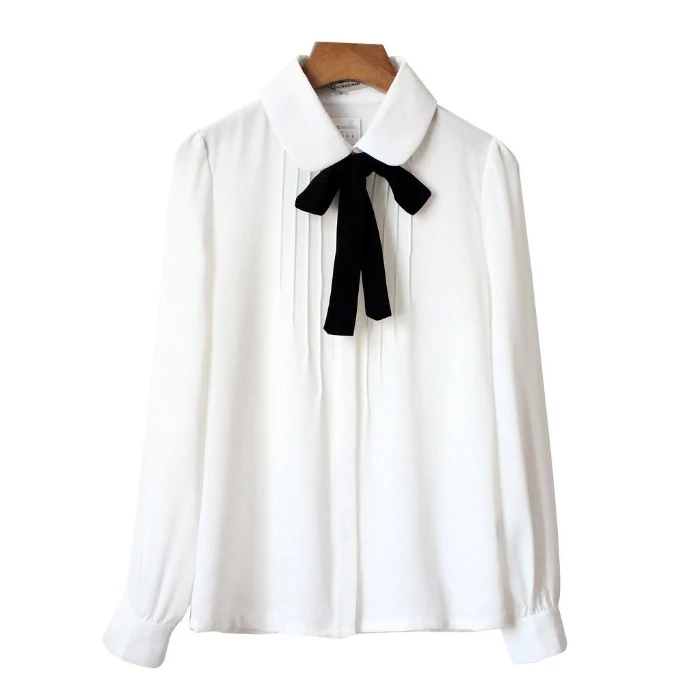 blouse in white, with a peter pan collar, and a black ribbon, tied into a bow, capsule wardrobe item, on a white background