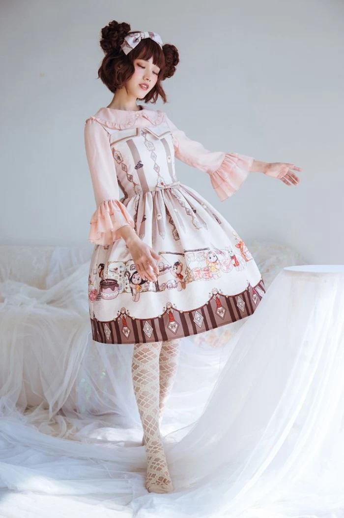 lolita fashion, off-white dress, with beige and brown motifs, worn over a pale pink shirt, with frilly sleeves, by a pale slim woman, in a brunette wig, featuring side buns