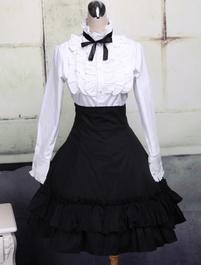 bib detail on a white shirt, featuring a black bow around the collar, define lolita, black frilled high-waisted skirt