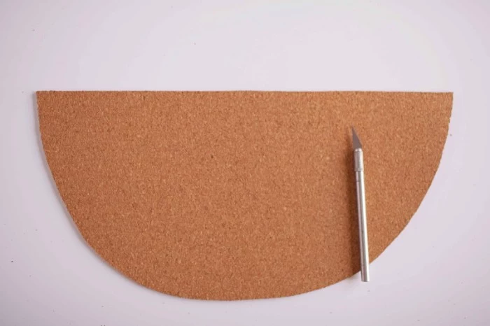 piece of beige cork, shaped like half a circle, placed on a white surface, cheap ways to decorate a teenage girl's bedroom, cutting cork with a box knife
