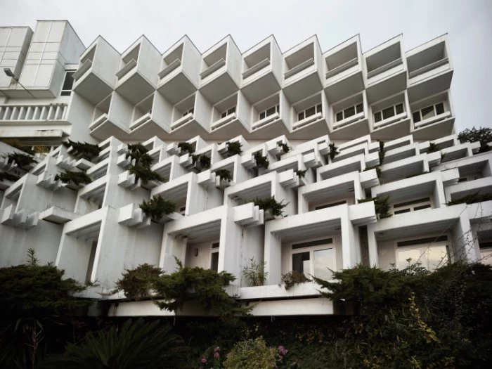 croatian hotel in opatija, made from multiple, white cube-like shapes, decorated with various green plants