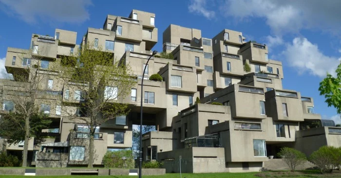 habitat 67 in motreal canada, large concrete building, made of multiple box-like structures, with rectangular windows, brutalism 