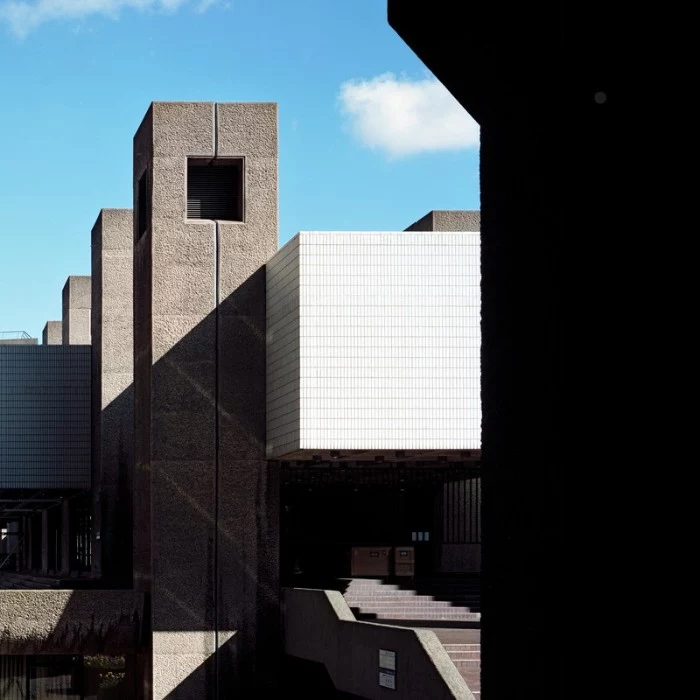 the barbican centre, in london england, examples of brutalism, building with rectangular shapes, covered in concrete and white tiles