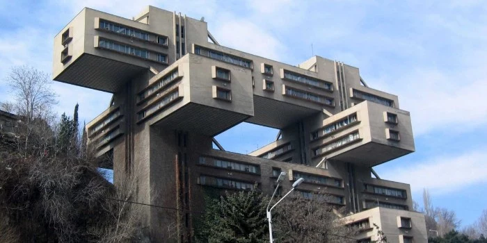 the headquarters of the bank of georgia, brutalist architecture example, tall concrete building, made up of crossing rectangular segments