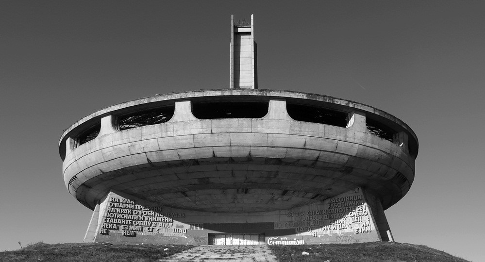 socialist building shaped like a flying saucer, made from concrete, and built on a podium, brutalist architecture, buzludzha monument in bulgaria