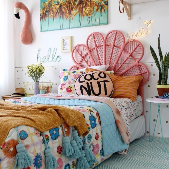 teenage girl room ideas, multicolored bed cover, on a single bed, with a pink, fan-like bed frame, potted plant and decorations nearby