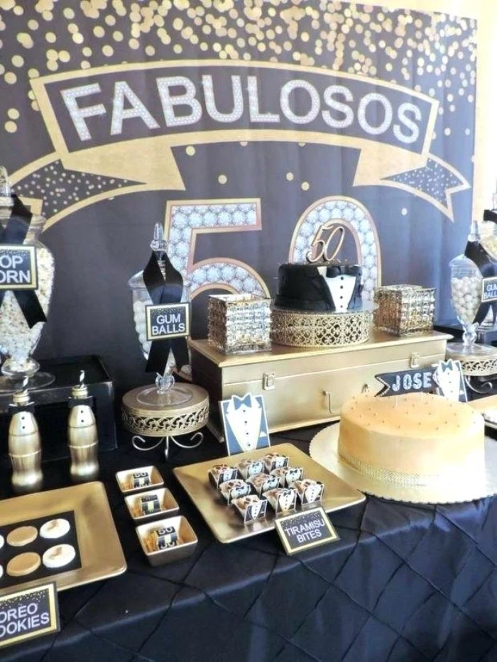 black and gold birthday theme, with small tuxedo decorations, and black ribbons, 50th birthday celebration ideas for husband, table with a selection of cakes and sweets