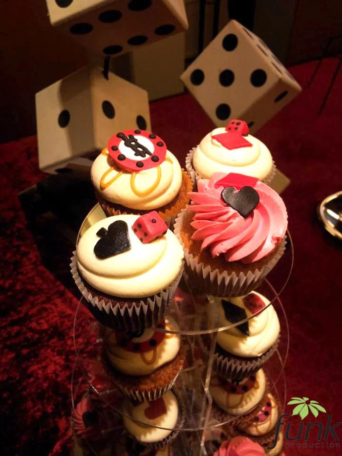 cupcakes with white frosting, decorated with various fondant shapes, in black and white, red and brown, playing card symbols, dice and gambling chips, 50th birthday party ideas for men, las vegas casino theme