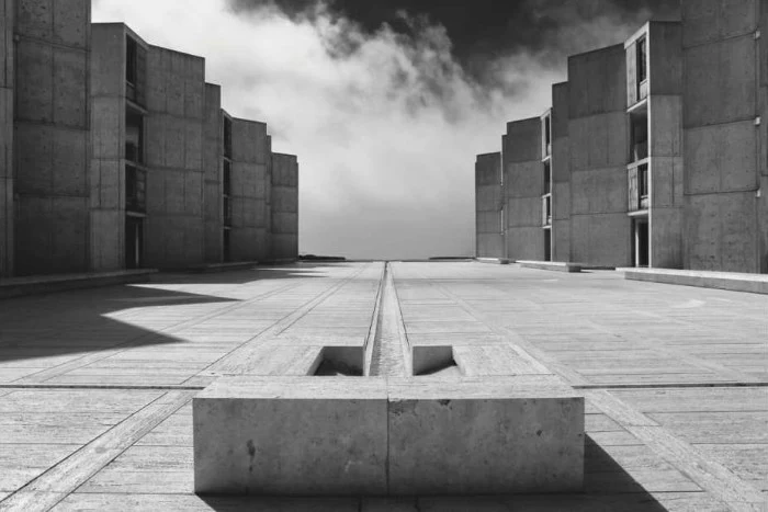 salk institute for biological sciences, in san diego california, brutalist art, courtyard covered in concrete, with angular buildings on either side