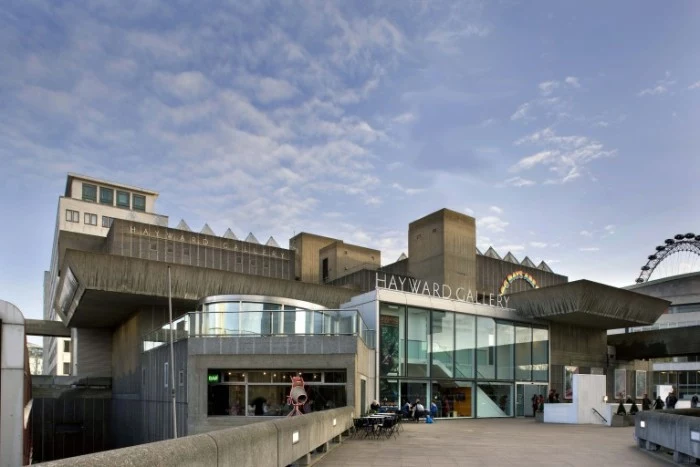 old brutalist design building, in dark grey, with large windows, the heyward gallery, in london england