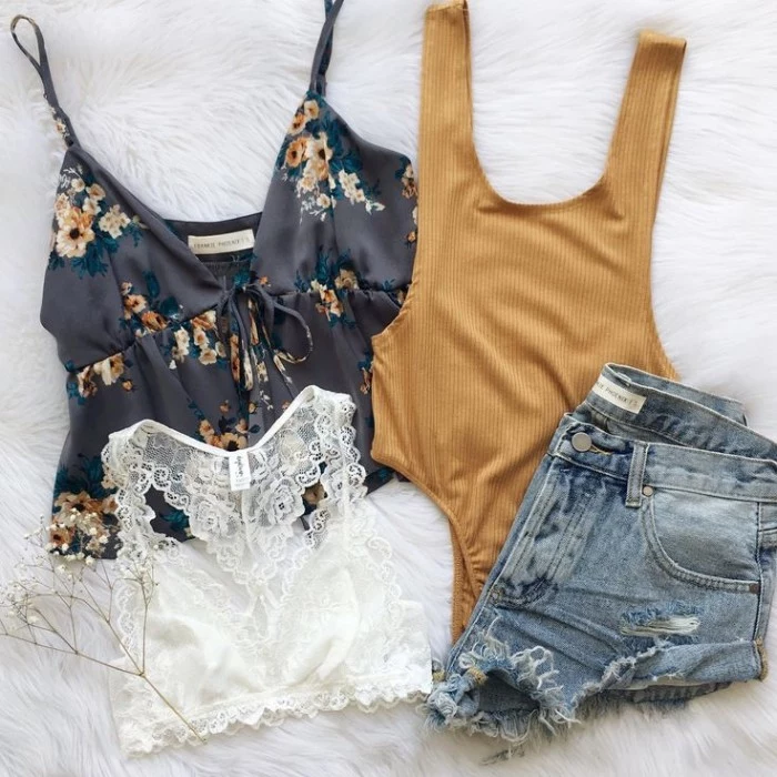 cutoff distressed light blue denim shorts, a white lace bralette, a mustard yellow body, how to wear a bralette, a black tank top with floral motifs