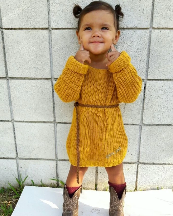 yellow knitted jumper dress, worn with a woven, thin brown leather belt, and cowboy boots, by a small child, girls thanksgiving outfit, simple and cute