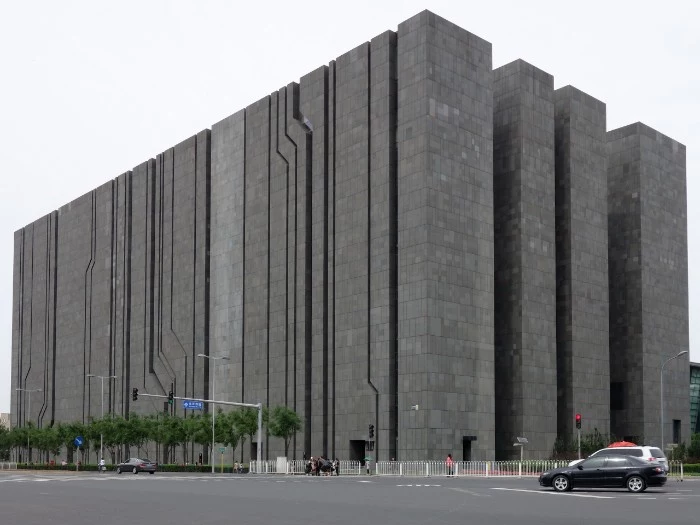 digital beijing building, a large rectangular structure, covered in dark grey concrete tiles, brutalism around the world, tall narrow sections