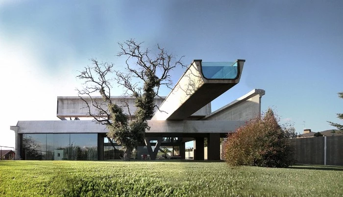 hemeroscopium house in las rozas spain, two storey concrete building, with large windows, and a long rectangular swimming pool, protruding from the second floor, brutalism today