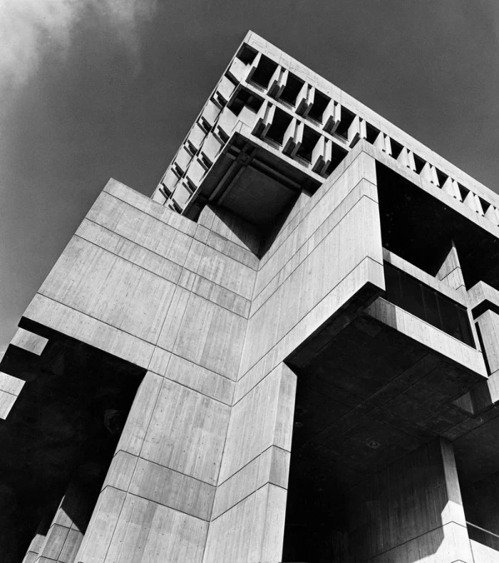 greyscale image of the boston city hall, seen from a low angle, iconic concrete architecture, qith angular elements