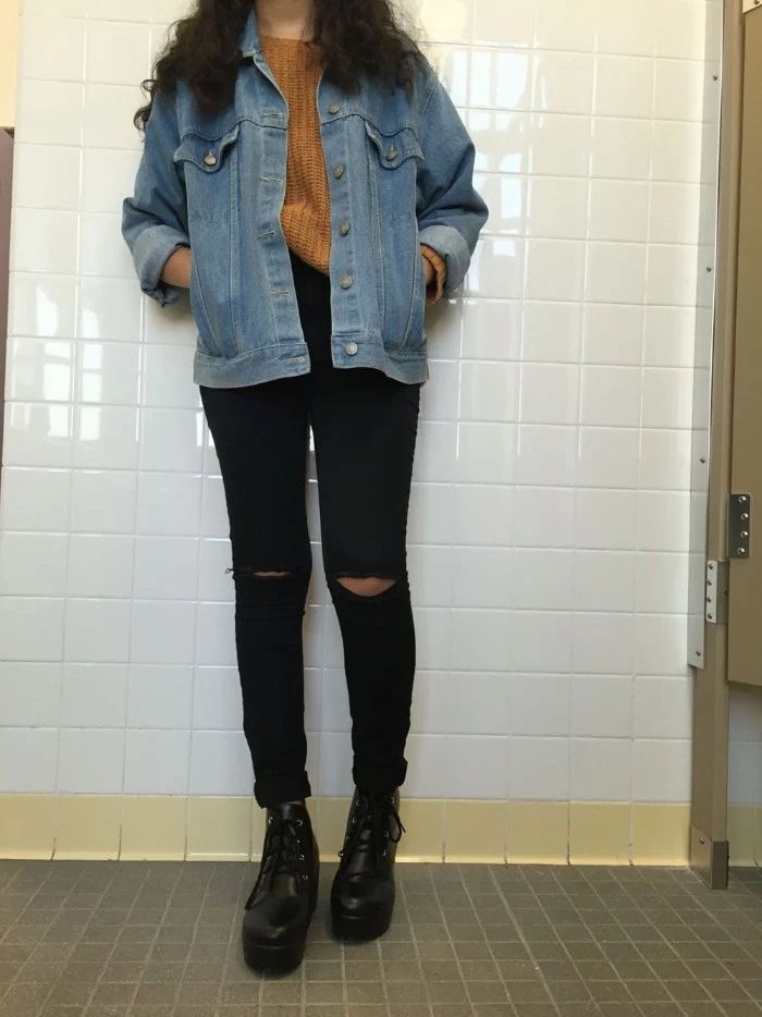 what a grunge girl looks like, ripped black skinny jeans, dark mustard yellow jumper, blue denim jacket, and black leather combat boots