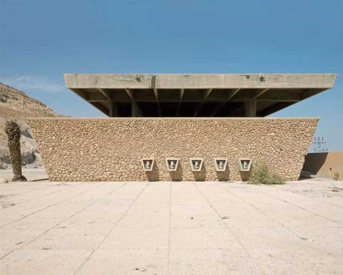 dead sea visitor center, in neve zohar israel, raw concrete structure, featuring beige natural stones, surrounded by desert