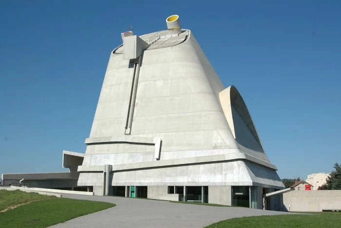 saint-pierre building in firminy france, made of pale grey concrete, without any visible wondows, brutalist design 