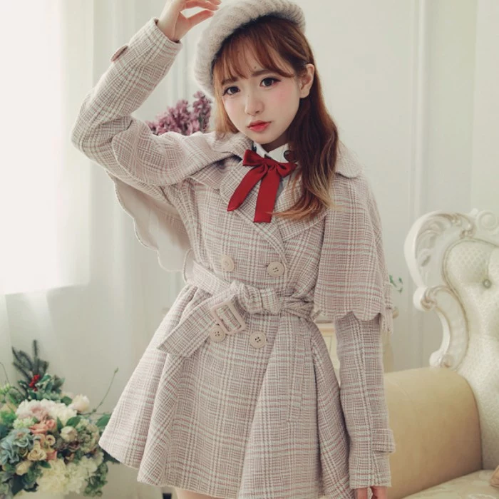 caped coat in beige plaid, with a red bow near the neck, worn by a brunette girl, in a white knitted baret, lolita fashion 