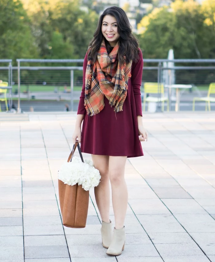 thanksgiving outfits, plaid blanket scarf, in beige and red, black and white, worn over a burgundy mini dress, with pale grey ankle boots