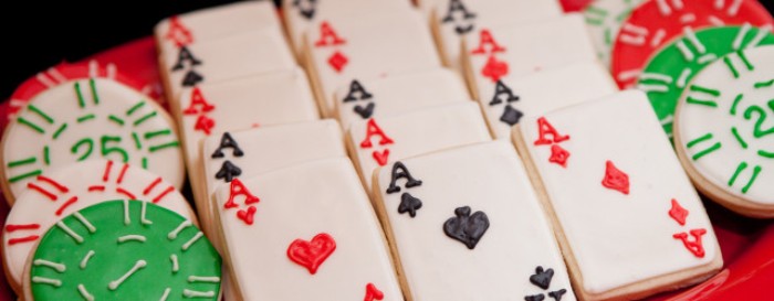 50th birthday party ideas for men, selection of round and rectangular cookies, decorated with white and black, green and red frosting, and made to look like playing cards and poker chips