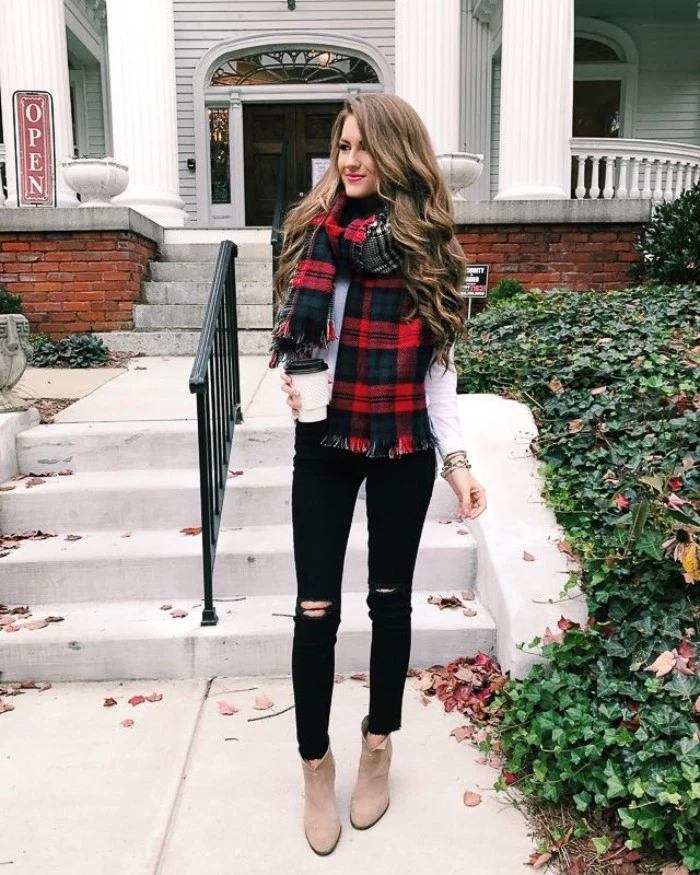 plaid blanket scarf, in red and black, combined with a white top, and worn over ripped, black skinny jeans, comfy outfits, light beige suede ankle boots 