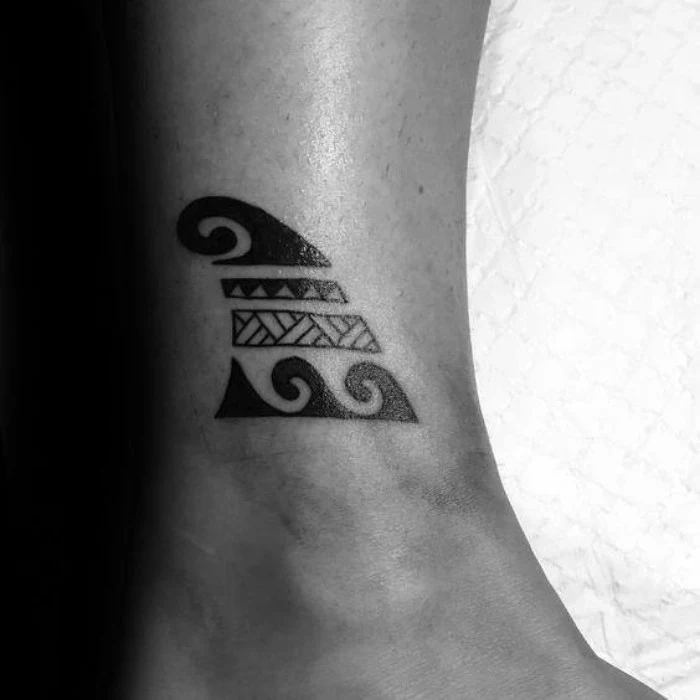 stylized shark fin tattoo, decorated with flourishes, and cross hatched patterns, tattoos with deep meaning, bravery and overcoming hardships, on a man's ankle