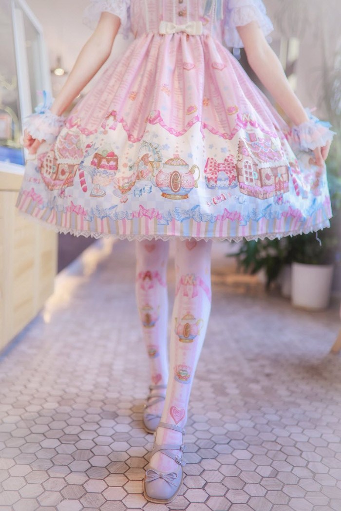 close up of a circular, pale pink skirt, with cute white and beige, blue and yellow motifs, what is lolita, worn over white patterned tights