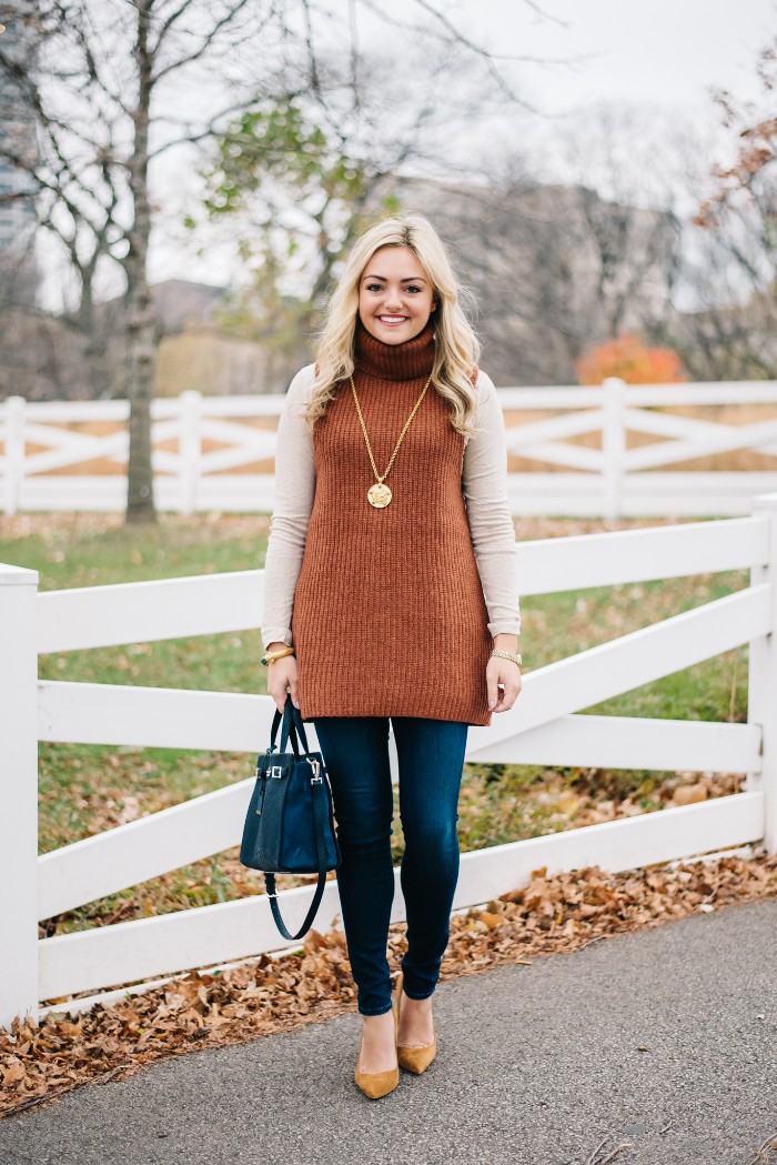 ribbed long sleeveless polo neck jumper, in light brown, worn over a white top, thanksgiving outfits for women, skinny dark blue jeans, yellow high heels