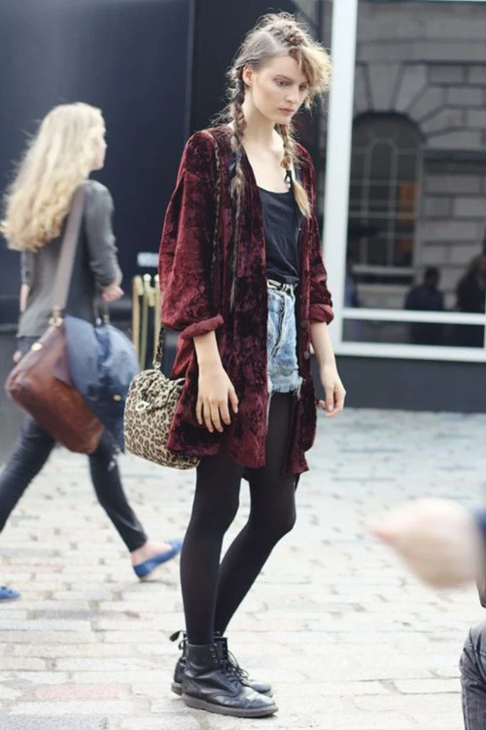 velvet cardigan in burgundy, worn over a black top, black opaque tights, and light blue cutoff denim shorts, by a slim young woman, with braided hair, and black leather combat boots