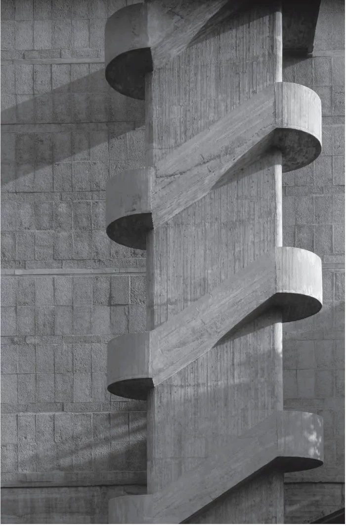 symmetrical concrete staircase, in front of a wall, covered in concrete tiles, brutalist architecture, black and white art photography