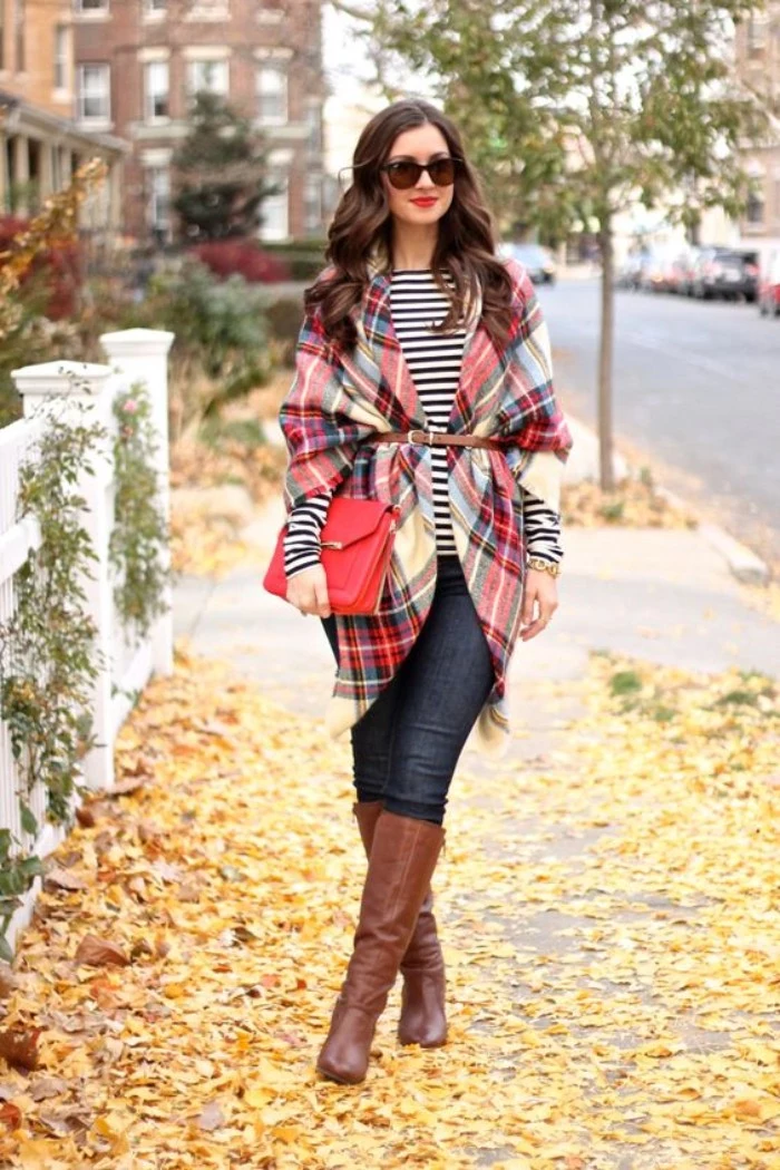 cardigan made from a plaid blanket scarf, tied with a thin, brown leather belt, worn over a striped, black and white top, and dark blue skinny jeans, tall brown leather boots, and a red clutch bag