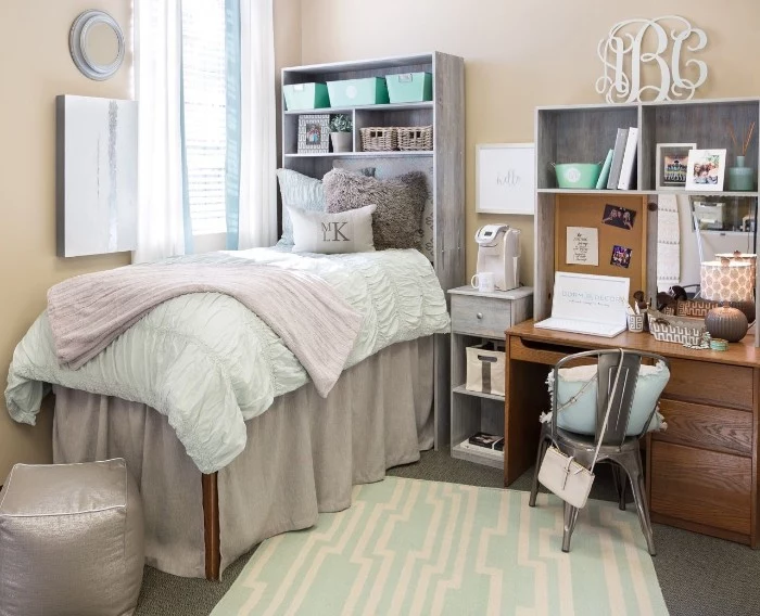 tall single bed, with pale beige, white and light pink bedding, cool beds for teens, in a room with cream walls, a wooden desk, and a grey chair